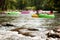 Defocused People Tubing Down River Approach Boulders In Focus