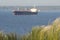 Defocused photo of a bulk carrier sailing on the sea. Seascape