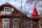 Defocused photo of a fragment of an old house in the forest against a blue sky