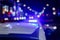 defocused photo of police car lights in night city with selective focus and bokeh