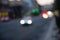 Defocused receding city traffic in the evening. Out of focus lights of traffic jam on city street. City blur background. Moving