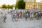 Defocused row of bicycles parking in squarestreet near fenced court and building