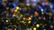 Defocused shimmering multicolored glitter confetti, black background. Holiday abstract festive bokeh light spots.