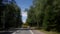 Defocused shot of driving car along country road at summer time. Out of focus.