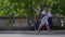 Defocused Shot of People and Traffic Moving In Front of Woman Sat On Bench 03. High quality