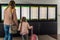 Defocused silhouette of family, young girl and her mother on airport terminal