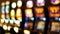 Defocused slot machines glow in casino on fabulous Las Vegas Strip, USA. Blurred gambling jackpot slots in hotel near