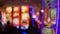 Defocused slot machines glow in casino on fabulous Las Vegas Strip, USA. Blurred gambling jackpot slots in hotel near