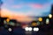 Defocused traffic and city lights on urban big street at dusk.