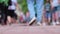 Defocused video - legs of people walking along the embankment in the seaside city. Tourists and vacationers
