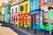 Defocused view of exterior of colourful small shops or restaurants, empty and closed due to coronavirus