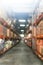 Defocused warehouse racks with cartons boxes as background