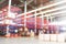 Defocused warehouse racks with cartons boxes as background