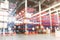 Defocused warehouse racks with cartons boxes as background