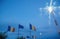 Defocused waving Romania and European Union flags waving at dusk with tall light