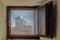 Defocused windmill seen through a window of another mill with fog in consuegra ... December 26, 2018. Consuegra Toledo Castilla La