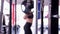 Defocused woman finishes barbell squat exercises, female athlete training in gym