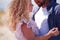 Defocused young adult couple at summer day. curly, blonde woman and bearded man