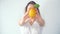 Defocused young woman showing fresh lemon