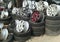 Defocusing Foto and zoom in. Stacked used auto tires and wheel rims in the car service center, next to the highway