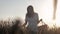 Defocusing Woman With A Basket In A Dress Is Walking In A Wheat Field