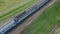 Deforestation along the railroad. Sawed trunks and large stumps are visible. Aerial photography. A train passes below