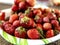 Defrosted strawberries on a plate, macro