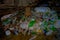 DEHRADUN, INDIA - NOVEMBER 07, 2015: Close up of garbage with plastic bottles, baskets, sacks in Tapkeshwar Mahadev