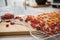 Dehydrate dried yellow and red tomatoes on stainless steel dehydrator tray and in glass jar for long term pantry in domestic