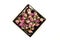 Dehydrated pink rose buds in a ceramic plate top down view