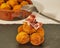 Delcious pincho of several round croquettes with a slice of Iberian Ham on a black slate board decorated with croquettes in a bowl