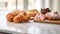 Delectable assortment of freshly baked pastries displayed on an elegant marble countertop. AI Generative