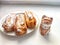 Delectable Dessert Pastries With Charming Porcelain Cat Figurines. Piped cakes sprinkled with sugar beside whimsical cat