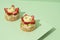 delectable desserts topped with fresh strawberries sitting on a plain white background