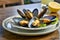 A delectable dish of fresh mussels served with a slice of lemon