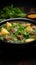 Delectable display Front view of savory meat soup with potatoes, greens on dark surface