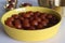 Delectable Gulab Jamun dessert on a rustic plate. Close up of golden fried milk balls in sweet syrup