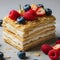 Delectable Layered Napoleon Pastry Topped With Fresh Berries on White Plate