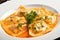 Delectable Ravioli with a Rich Lobster Sauce, Garnished with Chopped Parsley