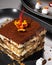 Delectable tiramisu with a flower artfully arranged on top
