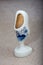 Delft Blue wooden shoe porcelain ornament.  Souvenir from Holland/Netherlands. Close up  on beige background