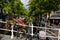 Delft, the netherlands, august 2019. The pretty and romantic canals. The aquatic plants create a green carpet, the bridges frame