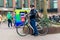 DELFT, the NETHERLANDS - JAN 18, 2014: Friendly Dutch policeman on a bicycle surveys on a busy square in Delft, the Netherlands