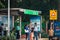 Delhi, India 03/07/2020: Daily office commuters waiting for a bus at the stop on roadside. Group of Indian people standing on a