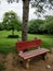 Delhi, India- 25th July 2018- A lonely Red Bench at the Mehrauli Archaeological Park gardens