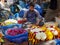 DELHI, INDIA - MARCH 14, 2019: worker making a flower garland at spice market of chandni chowk in old delhi