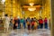 DELHI, INDIA - SEPTEMBER 19, 2017: Beautiful golden walls inside of the temple with crowd of people inside of the Sikh