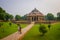 DELHI, INDIA - SEPTEMBER 19, 2017: Unidentified people posing for a picture in front of a beautiful tomb building of Isa