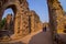 DELHI, INDIA - SEPTEMBER 25 2017: Unidentified people walking near of the ruins of the Qutub Minar tower, located on