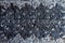 Delicate black lace on grey melange woolen fabric